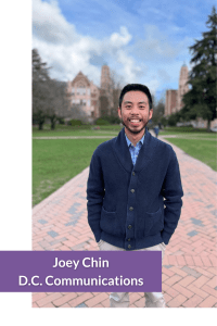 A smiling man stands on a brick pathway with a historic building in the background.